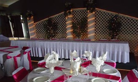 Banquet tables set for a reception in the Stage North hall